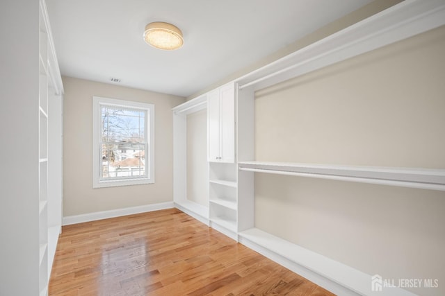 spacious closet featuring visible vents and light wood-style floors