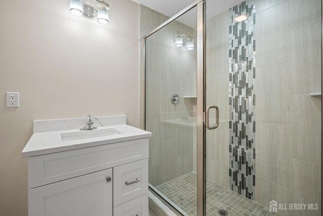 bathroom featuring a stall shower and vanity