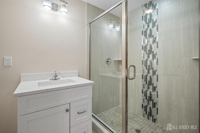bathroom featuring vanity and a stall shower