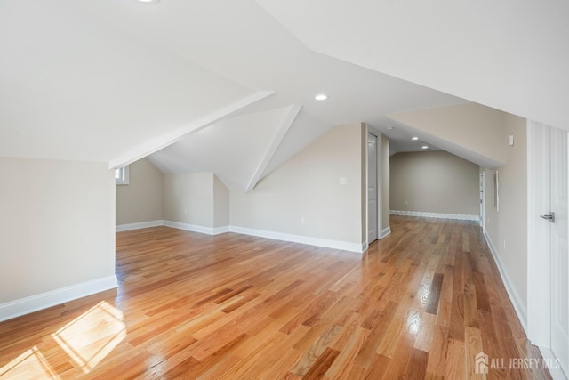 bonus room with recessed lighting, light wood-style floors, vaulted ceiling, and baseboards