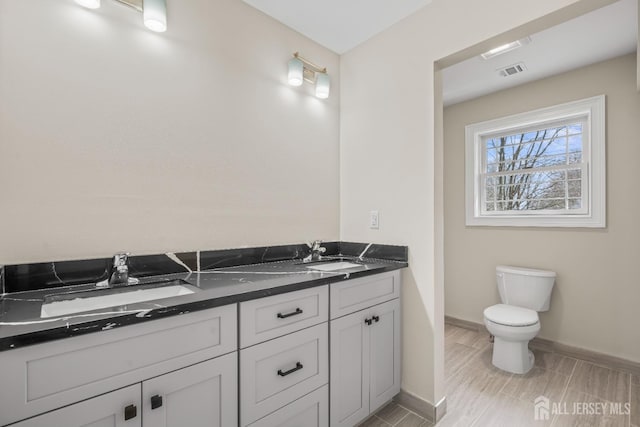 118 Cambridge Rd, Westfield, NJ 07090 - full bathroom featuring double vanity, baseboards, and toilet
