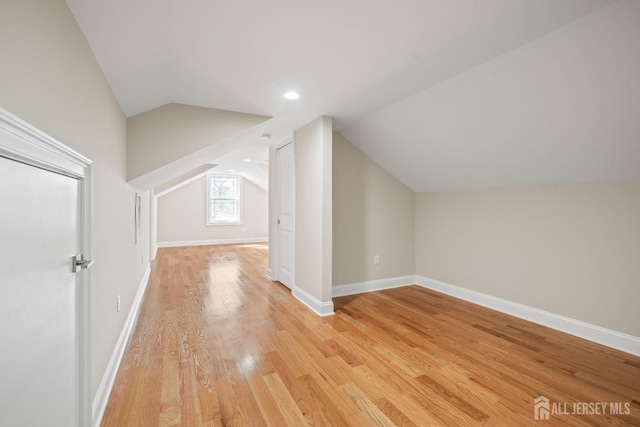 bonus room with recessed lighting, baseboards, lofted ceiling, and light wood finished floors