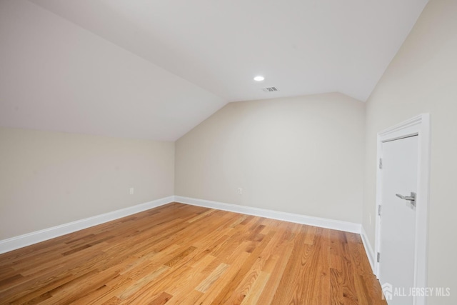 bonus room featuring recessed lighting, lofted ceiling, light wood finished floors, visible vents, and baseboards