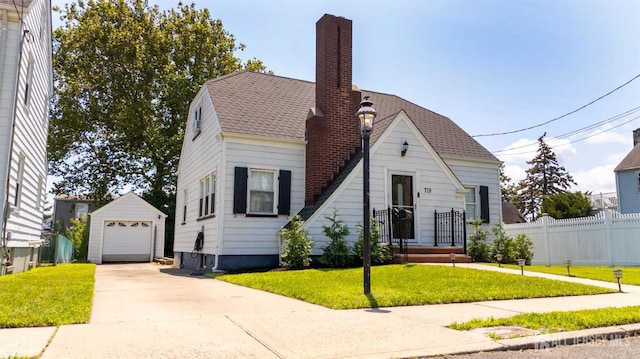 719 Charles St, South Amboy, NJ 08879 - view of front of property with an outbuilding, driveway, a chimney, a detached garage, and roof with shingles