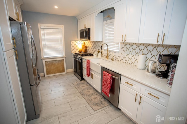 719 Charles St, South Amboy, NJ 08879 - kitchen with stainless steel appliances, healthy amount of natural light, tasteful backsplash, white cabinetry, and recessed lighting
