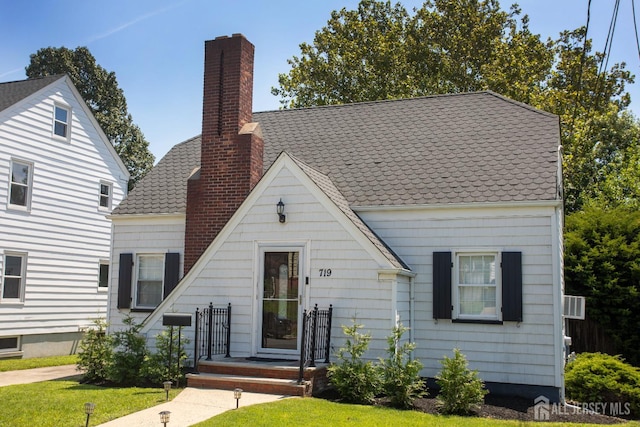 719 Charles St, South Amboy, NJ 08879 - view of front facade with a chimney and a front yard
