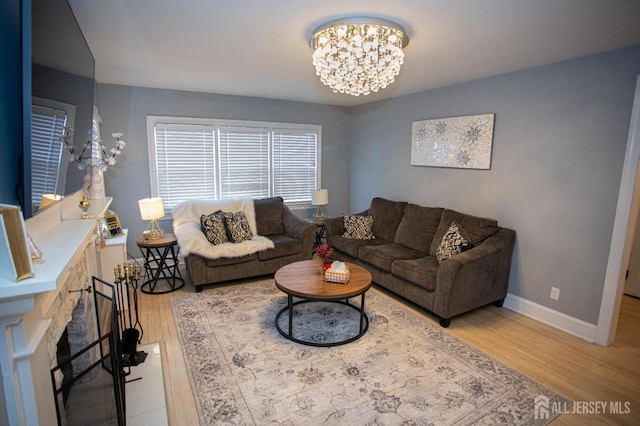 719 Charles St, South Amboy, NJ 08879 - living area featuring light wood-type flooring, a chandelier, and a fireplace