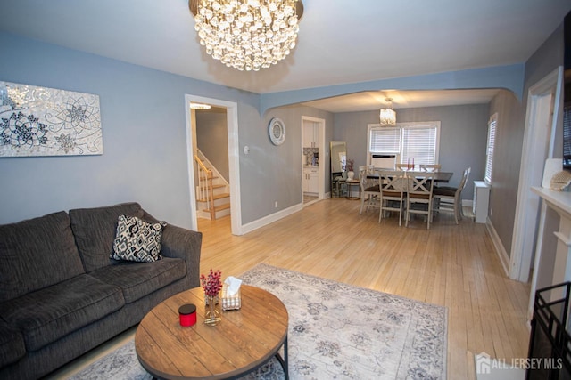719 Charles St, South Amboy, NJ 08879 - living area featuring a chandelier, stairway, and wood finished floors