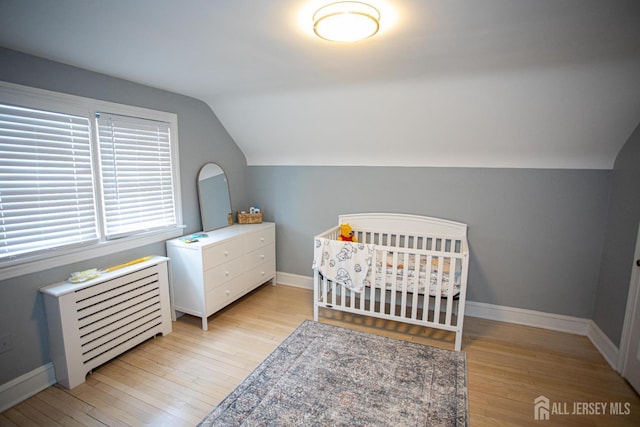 719 Charles St, South Amboy, NJ 08879 - bedroom with vaulted ceiling, light wood-type flooring, and a nursery area