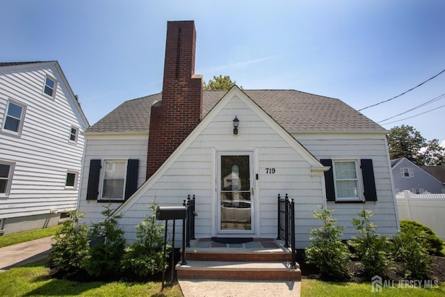 719 Charles St, South Amboy, NJ 08879 - view of front of home with a chimney and a shingled roof