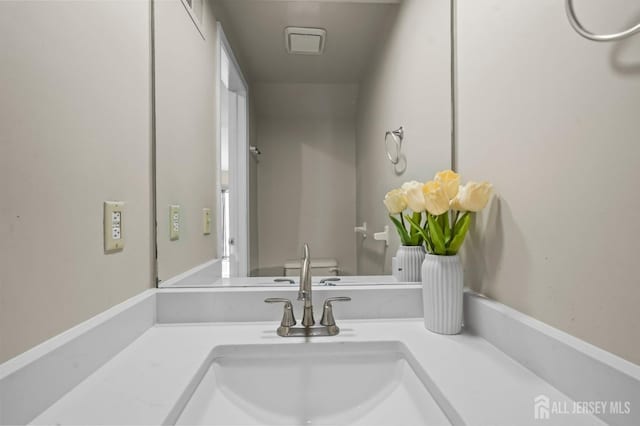 bathroom featuring vanity and toilet