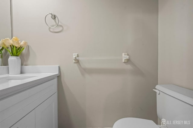 half bath featuring toilet and vanity