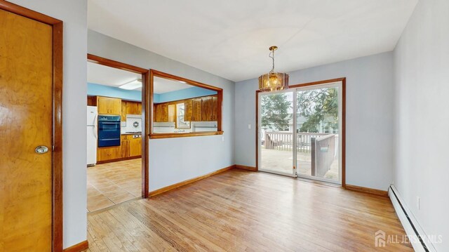 190 S Moetz Dr S, Milltown, NJ 08850 - spare room with baseboard heating, plenty of natural light, light wood-style floors, and a chandelier