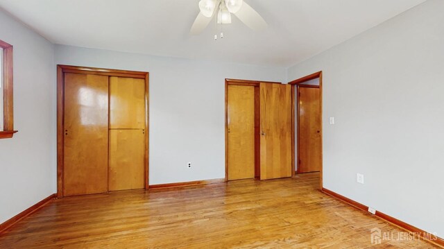 190 S Moetz Dr S, Milltown, NJ 08850 - unfurnished bedroom with two closets, light wood finished floors, baseboards, and a ceiling fan
