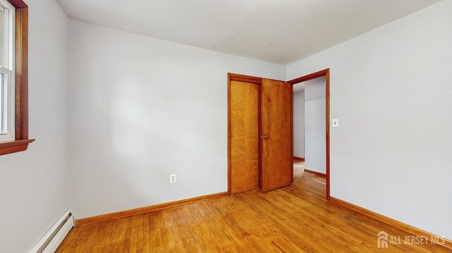 190 S Moetz Dr S, Milltown, NJ 08850 - spare room with a baseboard radiator, light wood-style flooring, and baseboards