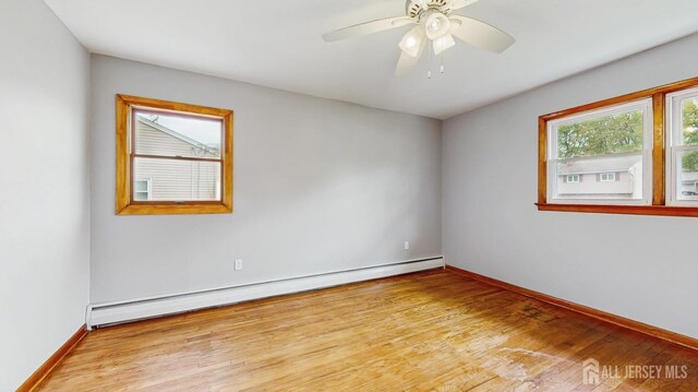 190 S Moetz Dr S, Milltown, NJ 08850 - empty room with a baseboard heating unit, wood finished floors, baseboards, and ceiling fan