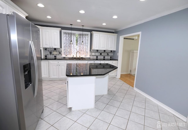 kitchen featuring dark countertops, light tile patterned floors, ornamental molding, and stainless steel refrigerator with ice dispenser