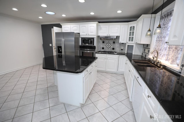 kitchen featuring light tile patterned floors, stainless steel appliances, backsplash, a sink, and under cabinet range hood