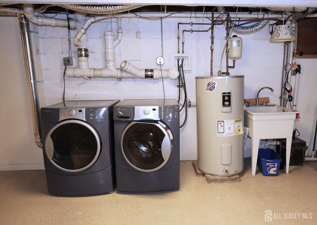 washroom featuring laundry area, separate washer and dryer, and electric water heater