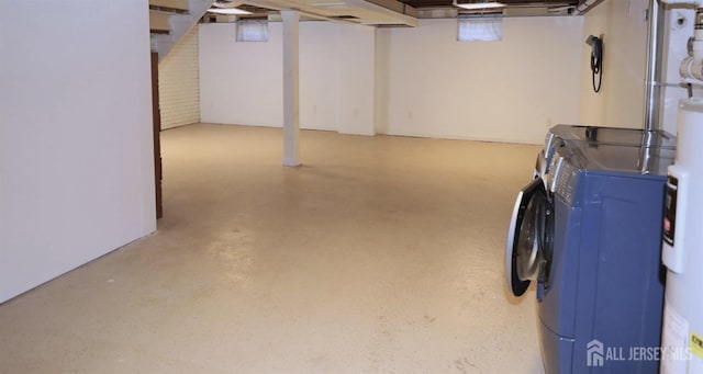 finished basement featuring washer and clothes dryer