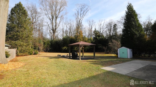 view of yard with an outbuilding, a gazebo, and a storage unit