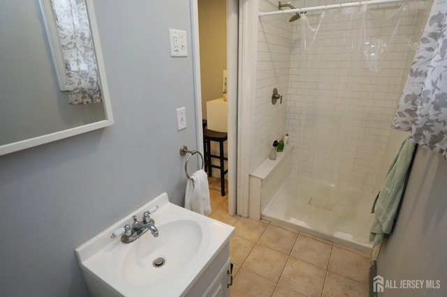 full bathroom with tile patterned floors, a shower stall, and vanity