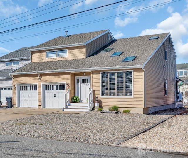 view of front of home with roof with shingles, concrete driveway, and an attached garage