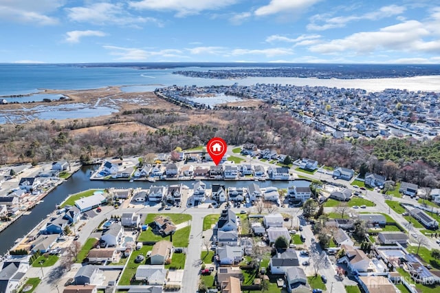 drone / aerial view with a residential view and a water view