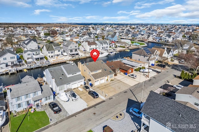 drone / aerial view featuring a residential view and a water view