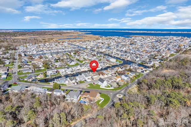 birds eye view of property with a water view and a residential view