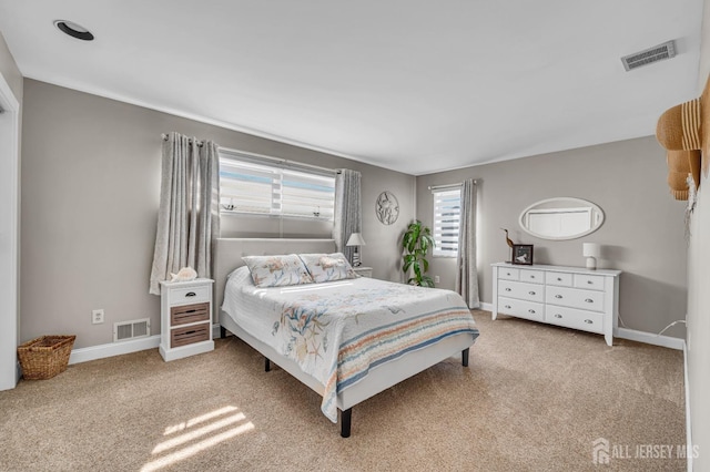 bedroom with visible vents, carpet, and baseboards