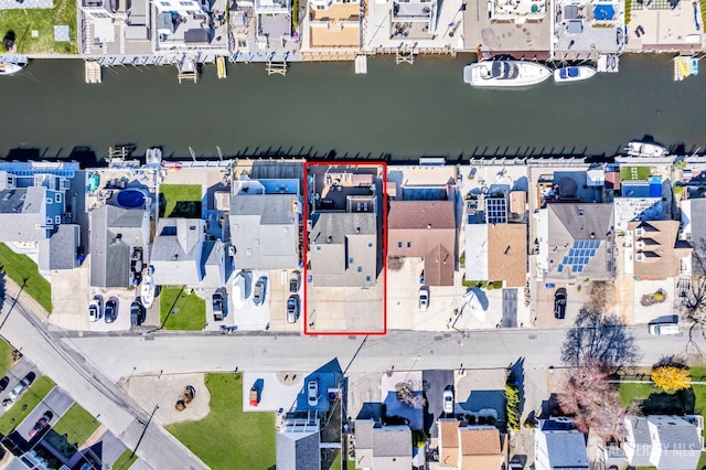 drone / aerial view featuring a residential view and a water view