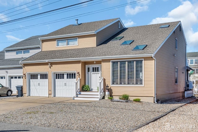 view of front of house with concrete driveway and roof with shingles