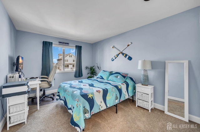 carpeted bedroom with baseboards