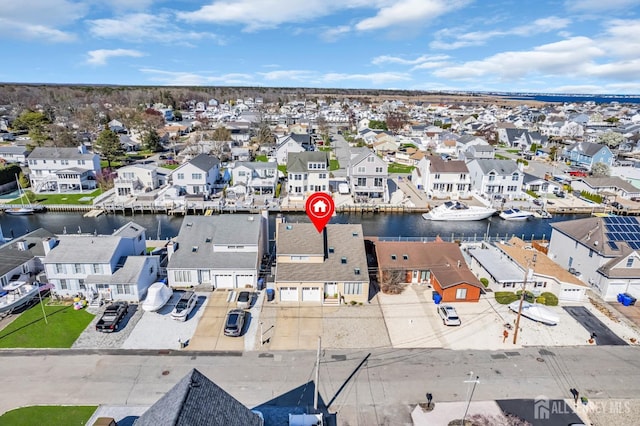 birds eye view of property with a residential view and a water view