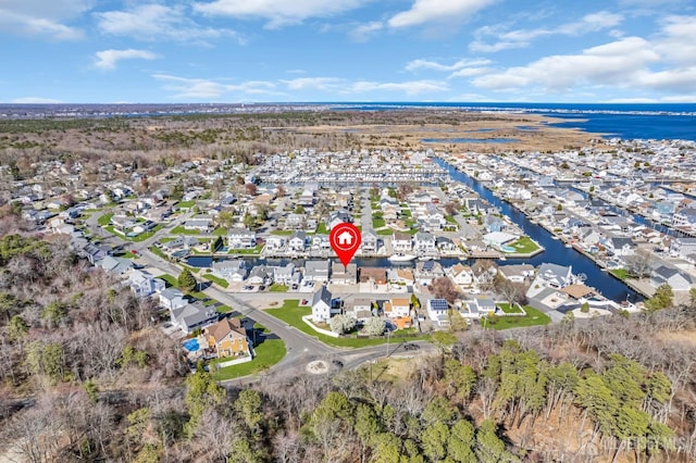 drone / aerial view with a residential view and a water view
