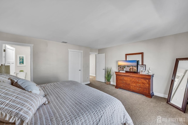 bedroom with baseboards, visible vents, and carpet