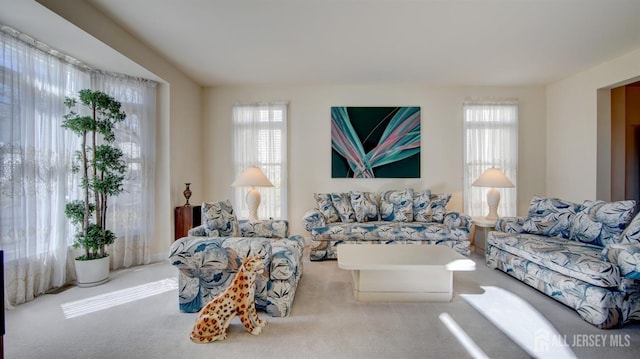 living area with plenty of natural light and carpet floors
