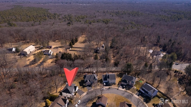 aerial view of property's location with a heavily wooded area