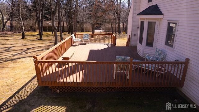 deck featuring view of wooded area