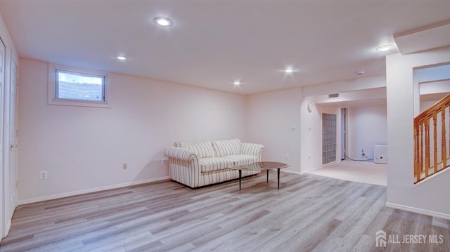 living area featuring light wood-style floors, stairs, recessed lighting, and baseboards
