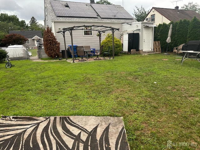 4 Fitzsimmons Ave, Middlesex, NJ 08846 - back of house with a pergola, a patio area, a shed, roof mounted solar panels, and roof with shingles