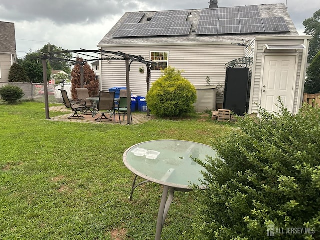 4 Fitzsimmons Ave, Middlesex, NJ 08846 - rear view of property with solar panels, a pergola, roof with shingles, and a patio