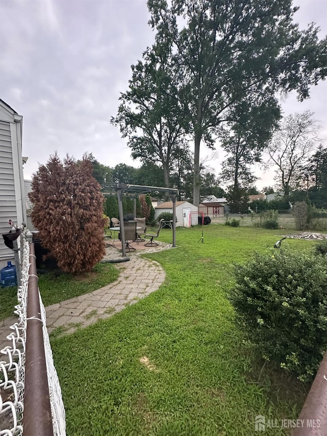 4 Fitzsimmons Ave, Middlesex, NJ 08846 - view of grassy yard with a storage unit, a pergola, and a patio
