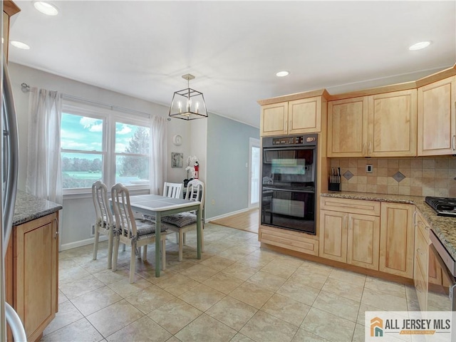 kitchen with light brown cabinets, tasteful backsplash, a chandelier, baseboards, and light stone counters