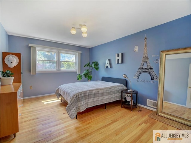 bedroom with light wood-style floors and baseboards