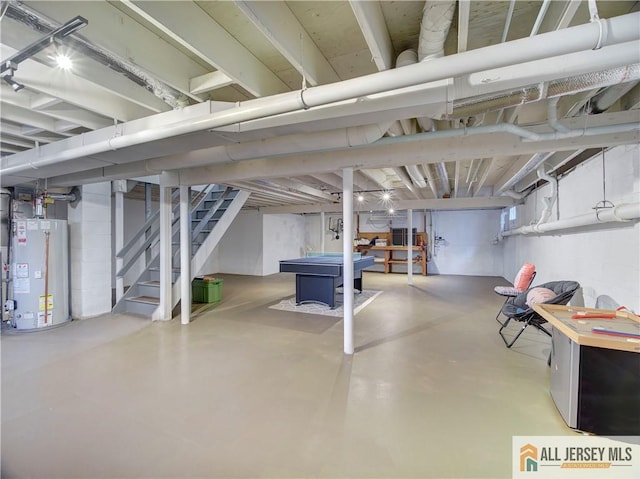 below grade area featuring gas water heater, stairway, pool table, and fridge