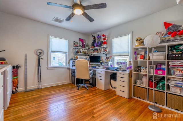 home office with wood-type flooring, ceiling fan, and baseboards