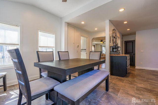 dining room with a ceiling fan, baseboards, dark stone finish flooring, and recessed lighting