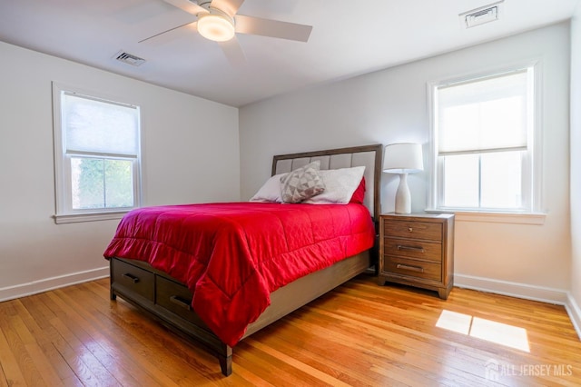 bedroom featuring light wood finished floors, baseboards, and a ceiling fan